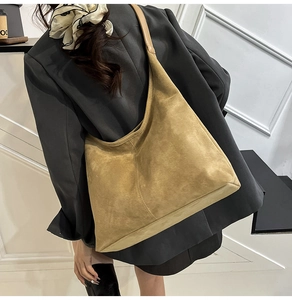 Detail of suede tote bag showing large capacity and minimalist hobo style on a model