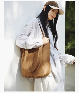 Brown canvas tote bag for women showing large capacity and durable shoulder straps