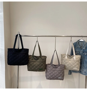 Quilted nylon tote bags in four colors hanging on a rack for daily fashion style