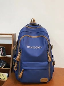 Deep blue minimalist laptop backpack on a wooden table with retro urban vibes