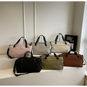 Detailed view of durable nylon travel bags in six various colors with adjustable straps