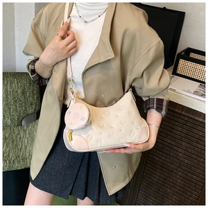 Detail view of cream dumpling crossbody bag with 3D bear pattern and round coin pouch