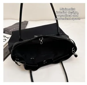 Top view of the interior compartment featuring a silver metal hook and inner zipper pocket