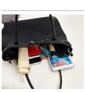Top view of a black tote bag showing spacious interior with tablet and daily essentials