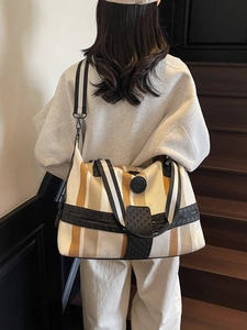 Striped canvas travel bag with large capacity, leather trim and crossbody strap