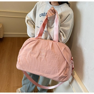 Pink large capacity travel bag with reinforced handles and mesh side pocket for fitness