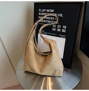 Detail of light brown suede hobo bag on a metal stand for a premium look