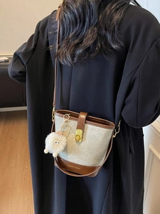 Sac seau chic en tweed et cuir marron avec breloque en peluche et fermoir métal