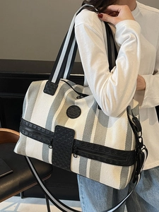 Large striped travel bag with shoulder strap and leather handles for gym and commute