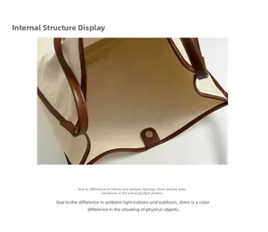 Detailed interior of the beige canvas tote bag with brown leather trim and magnetic closure