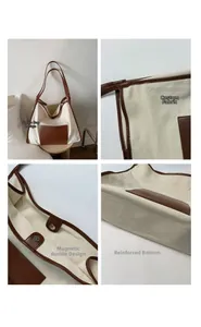 Detail view of canvas tote bag with brown leather trim and metallic hardware accents