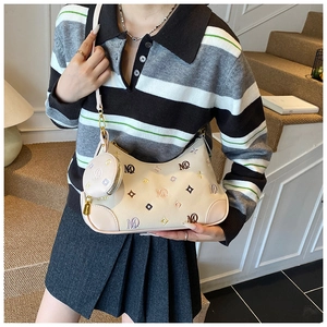 Detail view of beige crossbody bag with colorful MD letter embroidery and round coin purse
