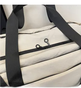 Detail of smooth two-way black zippers on durable beige fabric of travel bag
