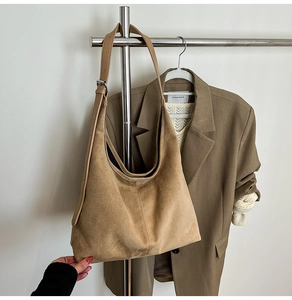 Detail of tan faux suede hobo bag featuring premium matte texture and reinforced stitching