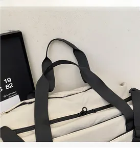 Close-up of durable nylon travel bag featuring reinforced black handles and adjustable strap