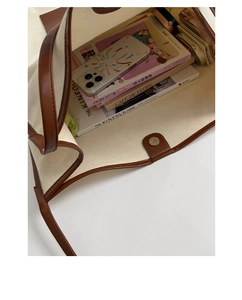 Spacious canvas tote interior showing magnetic closure and storage for books and phone