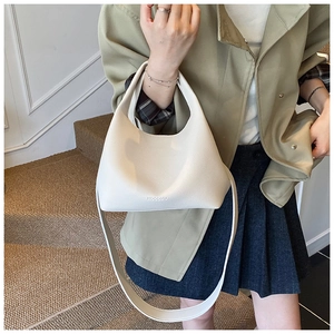 Detailed close-up of cream white hobo bag showing the lychee grain leather texture