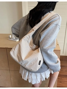 Minimalist beige canvas shoulder bag for women with large capacity shown in a lifestyle setting