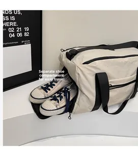 Close-up of the independent shoe compartment on this beige travel bag with zipper detail