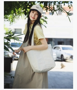 Detailed view of the large capacity canvas tote bag shoulder strap in natural outdoor light