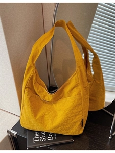 Minimalist bright yellow tote bag with pleated texture and spacious shoulder strap