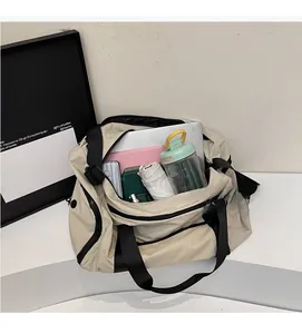 Beige travel bag showing spacious interior with laptop, bottle, and daily essentials
