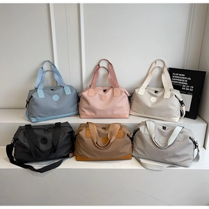 Detail view showing six colorful large-capacity travel bags with durable mesh fabric and straps