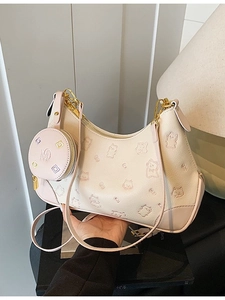 Chic dumpling-shaped crossbody bag in beige leather with cat emboss and round coin purse