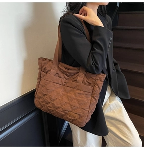 Close-up of brown quilted tote bag showing rhombus stitching and NingJia leather logo