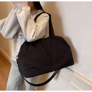 Detail of black large capacity travel bag with NING JIA logo and mesh side pocket