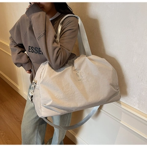 Detail of travel tote bag with breathable side mesh pocket and nylon texture