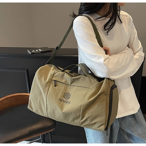 Olive green travel bag with dry-wet separation and NINGJIA logo detail shown on model