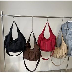 Four versatile crossbody nylon bags in black brown red and beige with multi-pocket design