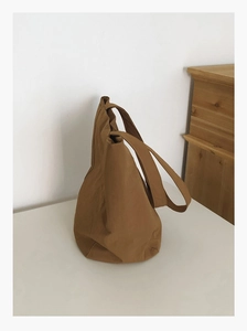 Close-up of caramel canvas tote bag showing soft textured fabric and durable stitching