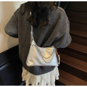Chic silver metallic shoulder bag with decorative chain and colorful bead charm detail