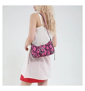 Detail of pink snakeskin pattern shoulder bag with a large silver metal buckle and strap