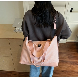 Pink large capacity travel tote bag shown from back view with dual straps for easy carrying