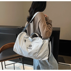 Close-up of stylish light blue travel bag featuring wet-dry separation and a side shoe compartment