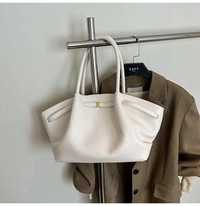 Close-up of white lychee pattern tote bag with minimalist square gold metal buckle detail