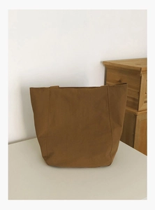 Detail of a large brown tote bag made of thick canvas fabric for daily casual use