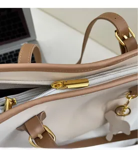 Close-up of smooth golden zipper and refined stitching on a large tote handbag