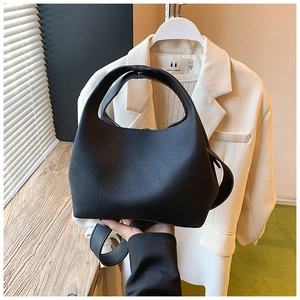 Close-up of black lychee grain leather bucket bag with arched handle and brand logo