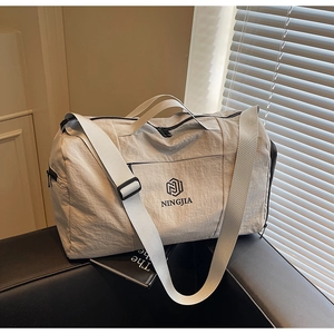 Detail of travel bag with NINGJIA logo, waterproof fabric, and sturdy carry handles