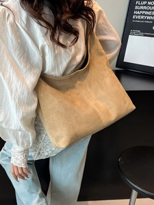 Fashionable camel suede hobo tote bag for women featuring large capacity and shoulder strap