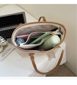 Top view of large tote bag interior showing ample storage space for a tablet and umbrella