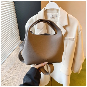 Close-up of khaki lychee grain leather bucket bag with HOCOMU logo and adjustable strap