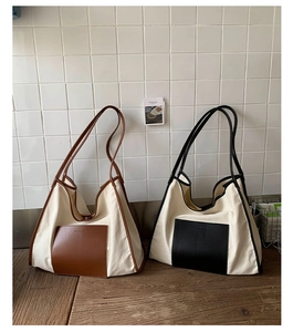 Detail of leather pocket and brand logo on canvas tote bags in brown and black