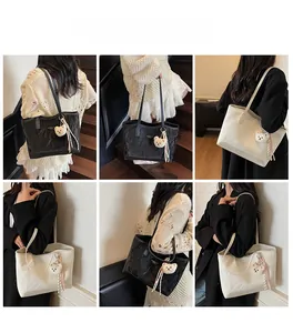 Detailed views of minimalist tote bags in black and beige with plush bear charms