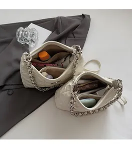 Detailed interior of quilted chain bucket bag showing spacious storage compartments