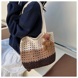 Detail of gradient woven tote bag with hollow honeycomb mesh and cute bear charm